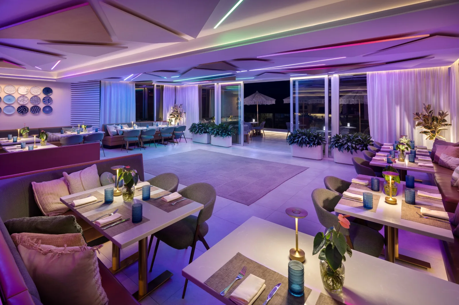 Private event room illuminated with purple and green evening lighting