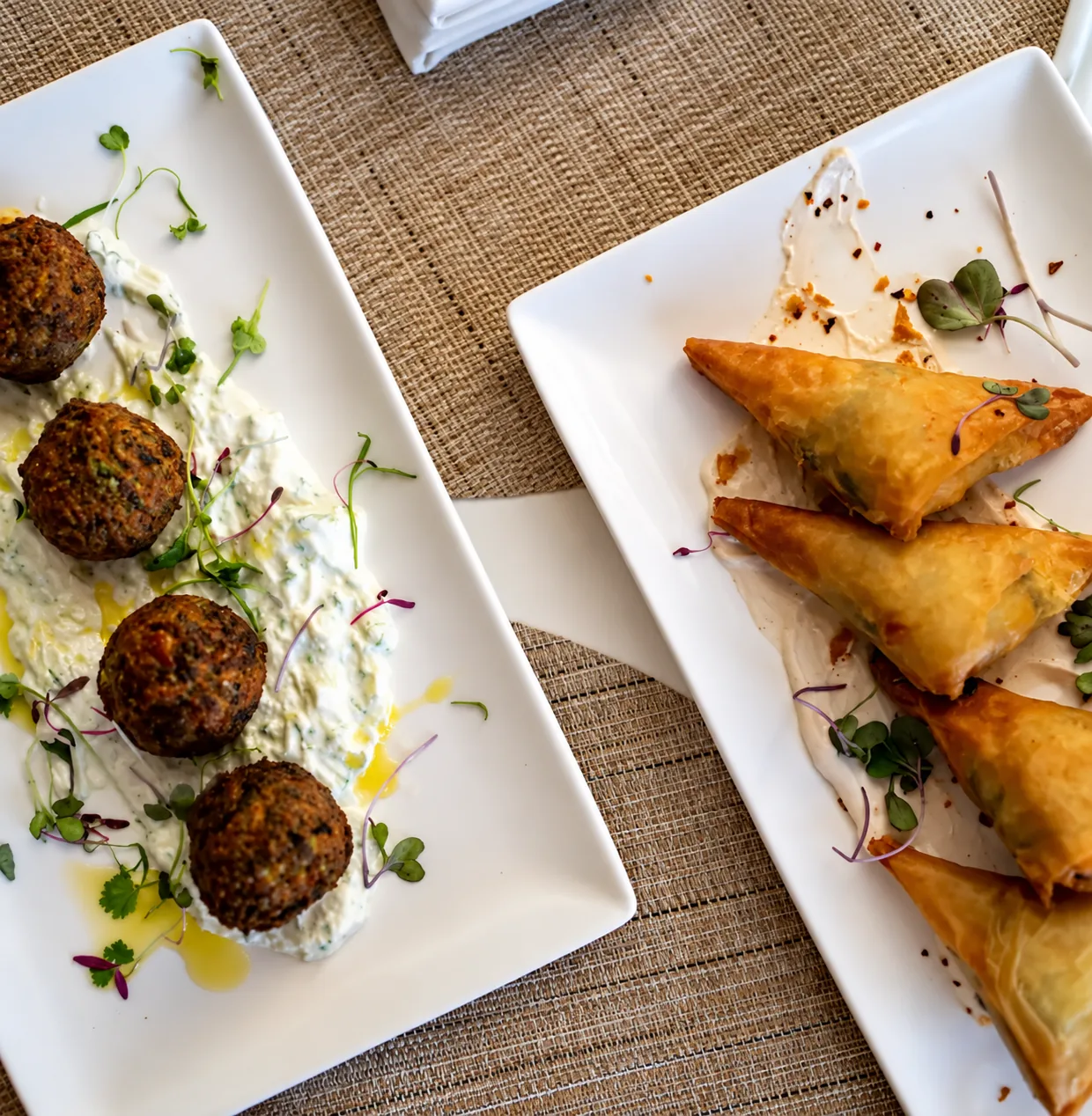 Appetizer plates with fritters and triangular pastries at Kalypso Beach