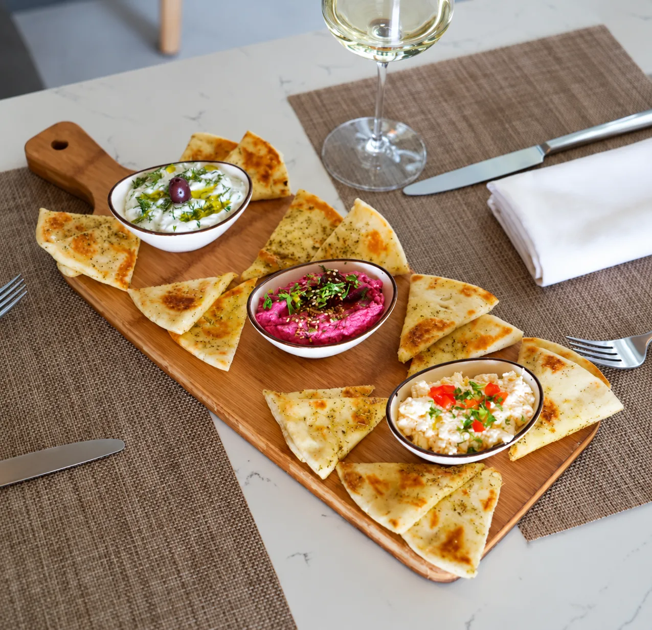 Three Mediterranean spreads with pita bread at Kalypso Beach